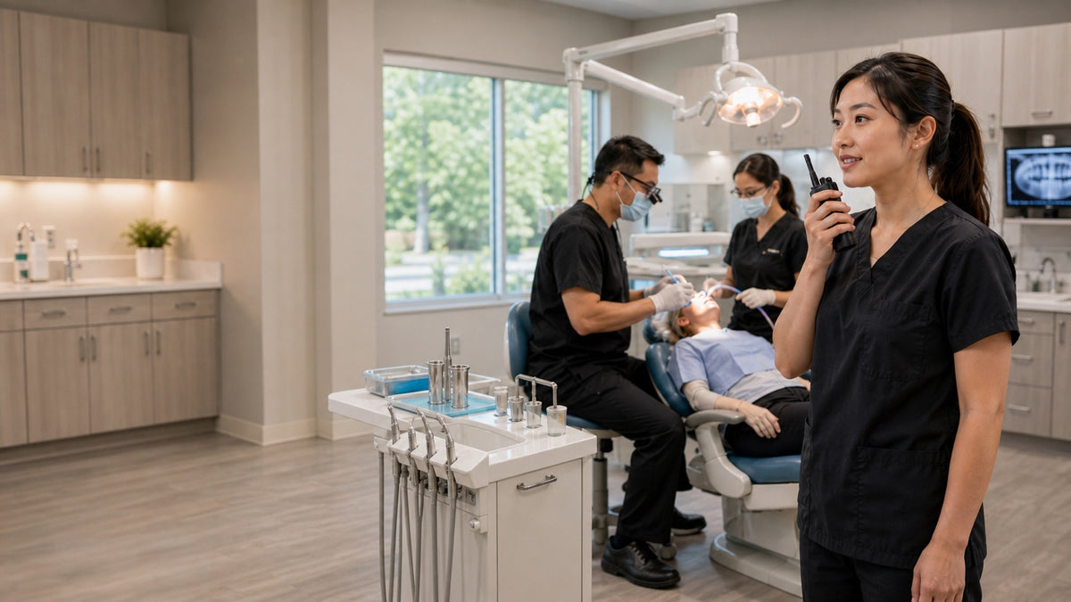 Dental practice team member using a two-way radio between operatories.
